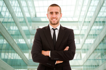 A handsome young business man at a modern office building