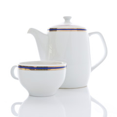 Ceramic teapot and cup on the white table