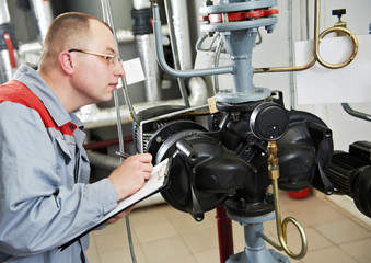 heating engineer in boiler room