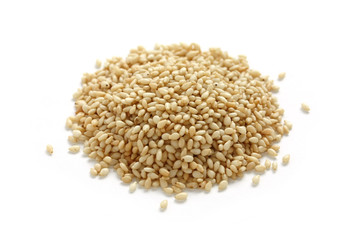 white sesame seeds piled on white background