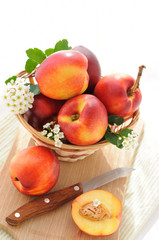 Fresh, ripe nectarines in a basket on board