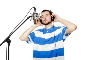 young guy with a beard in the headphones and microphone.