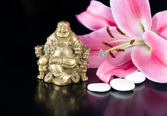 buddha with stones and lily flower