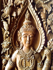 carved angel on wooden texture