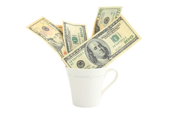US Dollars in a glass cup on a white background