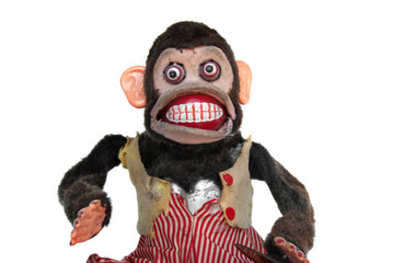 Damaged mechanical chimp with ripped vest, uneven eyes