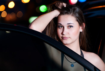Fototapeta na wymiar Girl by the car in the night