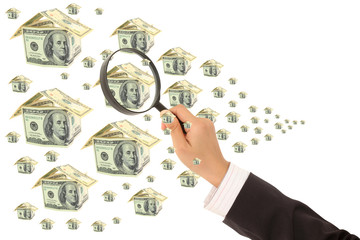 Money and magnifying glass in hand - business background
