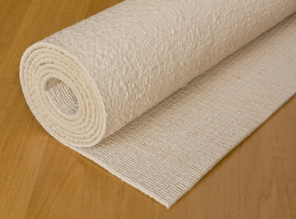 rolled up execise mat used for yoga or pilates