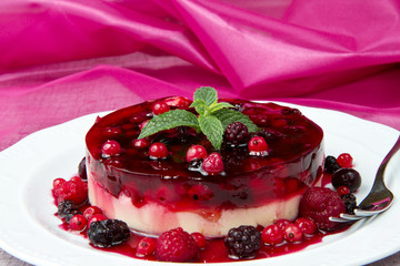 A berry fruits tart on a glass cake stand