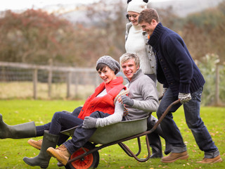 Two young couples playing in wheelbarrow