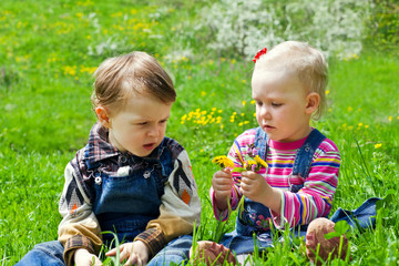 Boy and girl sitting in the grass