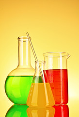 Laboratory glassware on yellow background