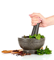 Mortar and pestle, parsley and pepper isolated on white