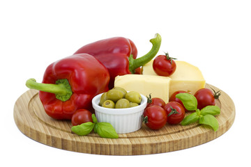 yellow cheese with fresh vegetables isolated on white background