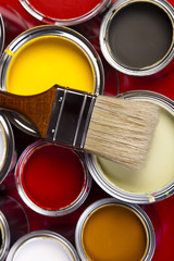 Cans of paint with paintbrush