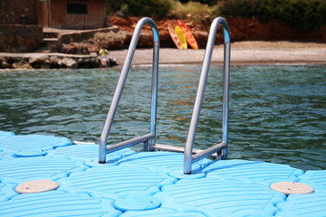 stairs to water on the swimming pier in the see