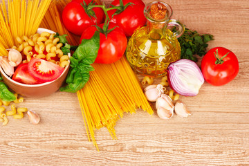 spaghetti with garlic, onion, spices  and basil on a yellow back