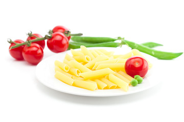 tomato, peas and pasta on a plate isolated on white