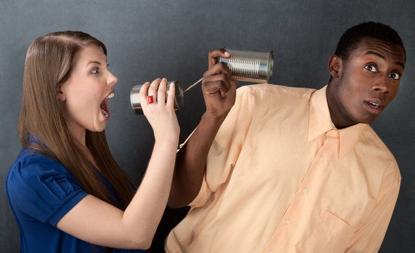 Woman Yelling at Man Through Stringed Cans