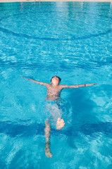 teenager swims in pool
