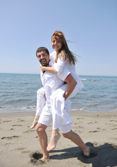 happy young couple have fun on beach