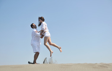 happy young couple have fun on beach