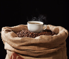 A cup of coffee and coffee beans