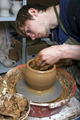 hands of a potter, creating an earthen jar on the circle