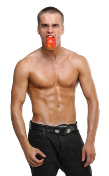 Muscle sexy wet naked young man eating the red apple