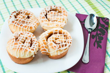Four rolled muffins with cinnamon and glaze