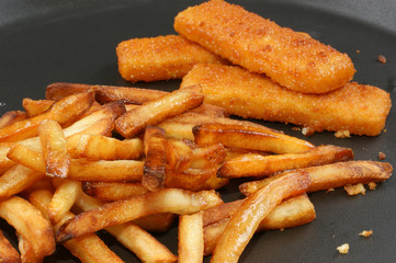 Fischstäbchen mit Pommes frites auf einer Pfanne