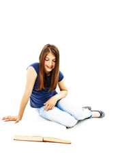 Attractive teenage girl reading a book