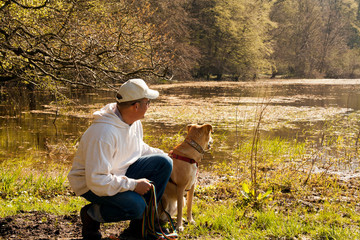 Pause mit Hund und Mann am Teich