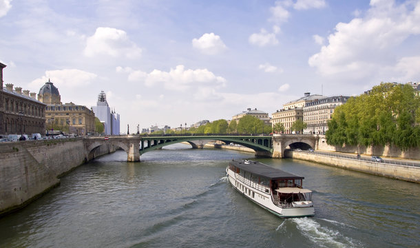 Passenger ship boat sails on the river Seine. Paris