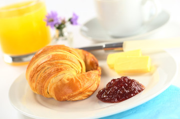Continental breakfast with croissant and strawberry jam