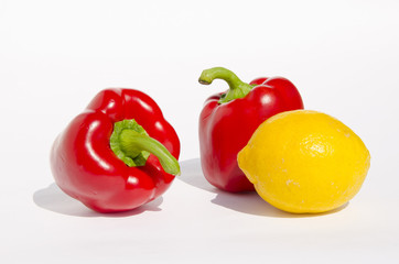 Red paprikas and yellow lemon.