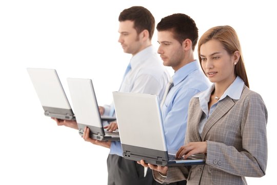 Young businesspeople with individual laptops