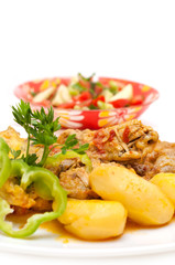 Chicken and potatoes cooked in tomato sauce isolated on white
