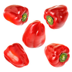 Five fresh red peppers isolated on white background