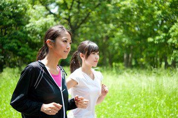 beautiful asian women jogging in the park