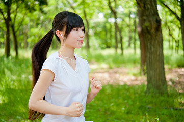 beautiful asian woman jogging in the park