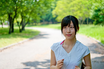 beautiful asian woman jogging in the park