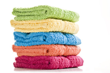 Colorful towels on a white background with space for text