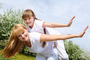 Naklejka premium girl with mother in spring park