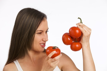 Young woman holding fresh tomatoes