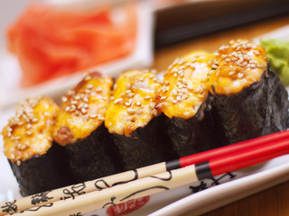 hot sushi on plate with  chopsticks
