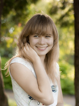 Portrait of young smiling girl in the park