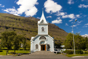Fototapeta na wymiar Wooden old blue church in Seydisfjordur village - Iceland
