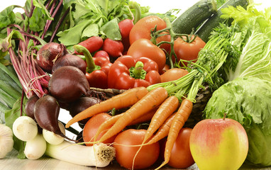 Composition with raw vegetables and wicker basket